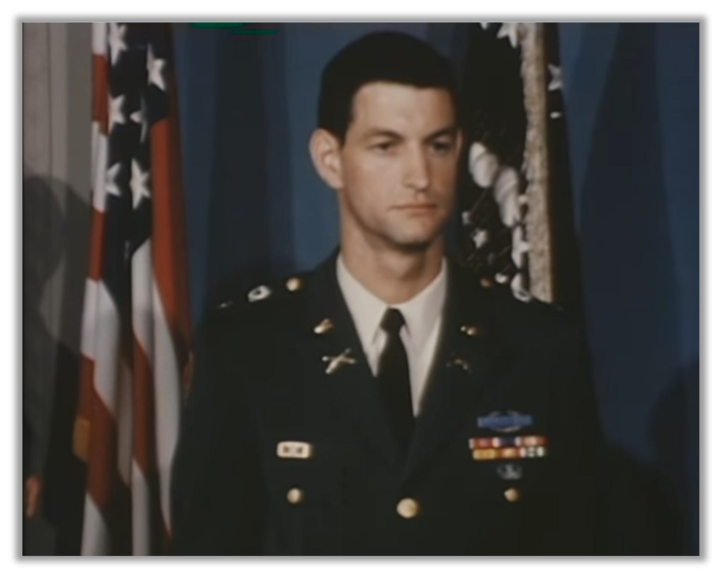 Foley is pictured at his Medal ceremony with an American flag in the background.