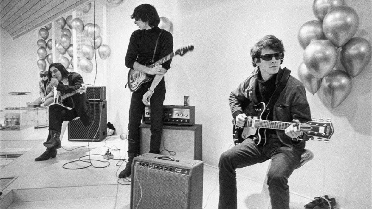 A screenshot from The Velvet Underground of the band with their instruments