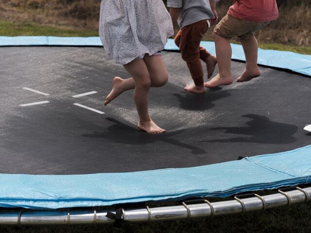 The Condon and Thompson cousins play together on the trampoline. 