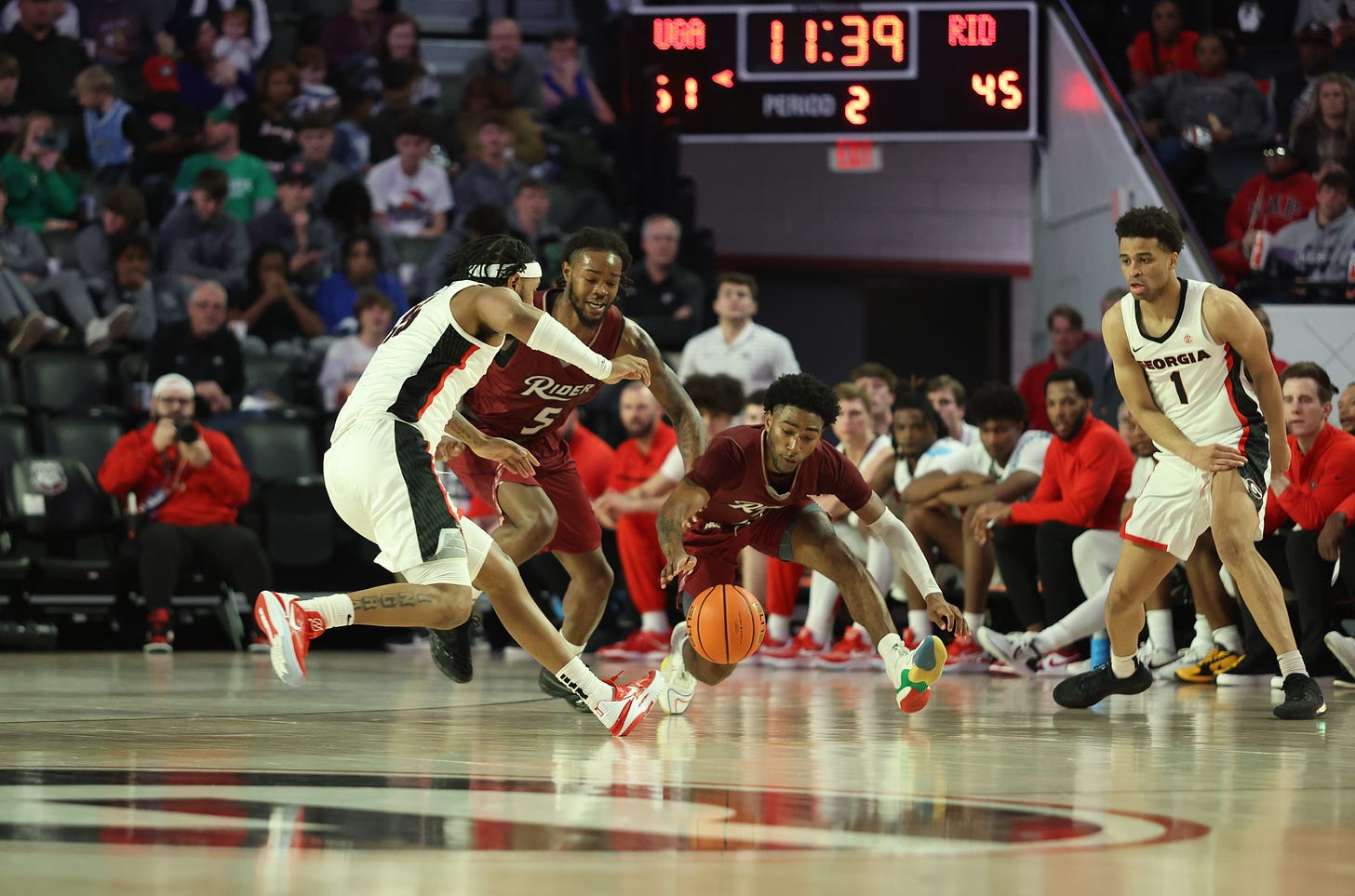 Rider’s Mervin James (5) and Allen Powell go for a loose ball against Georgia on Dec. 28, 2022. (Photo courtesy of Rider Athletics)
