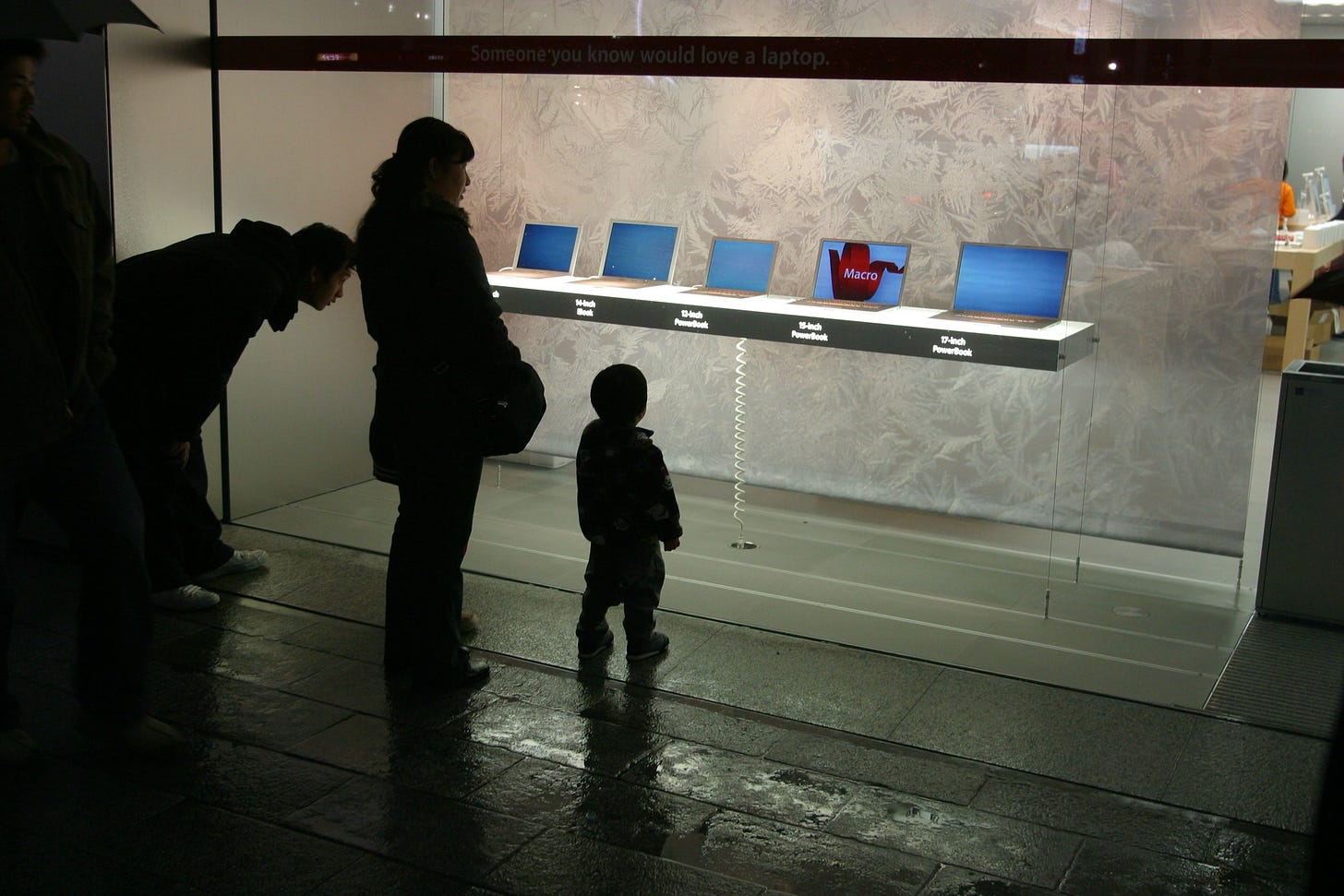 A child and two adults reflect on window displays outside Apple Ginza in Tokyo. This is my favorite photo Gary Allen ever posted.