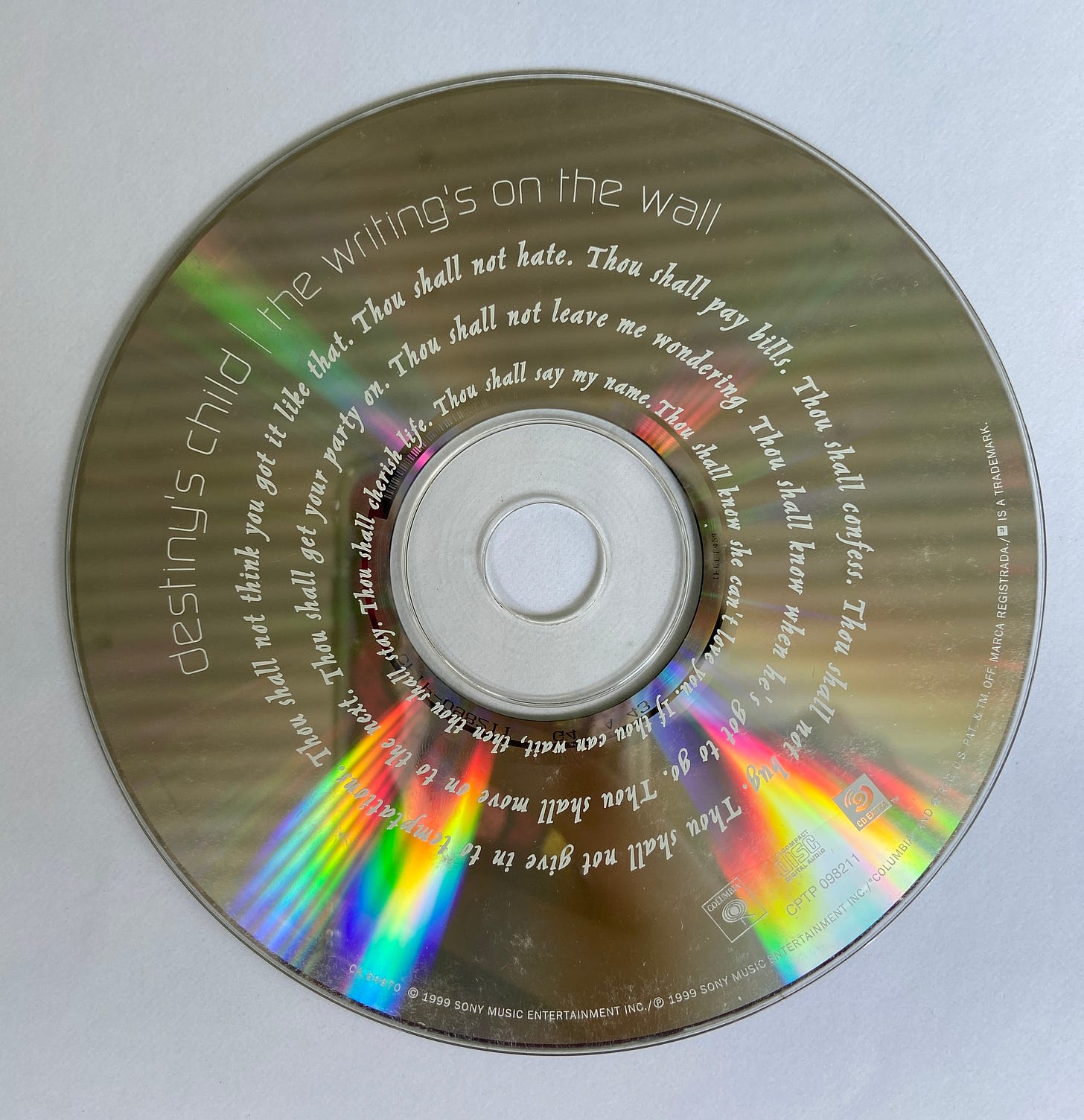 a reflective and refractive CD with text on it. Destiny's Child - The Writing's on the Wall.