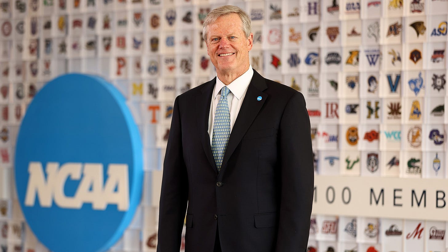 NCAA President Charlie Baker is shown in front of the membership logo wall in the lobby of the national office in Indianapolis.