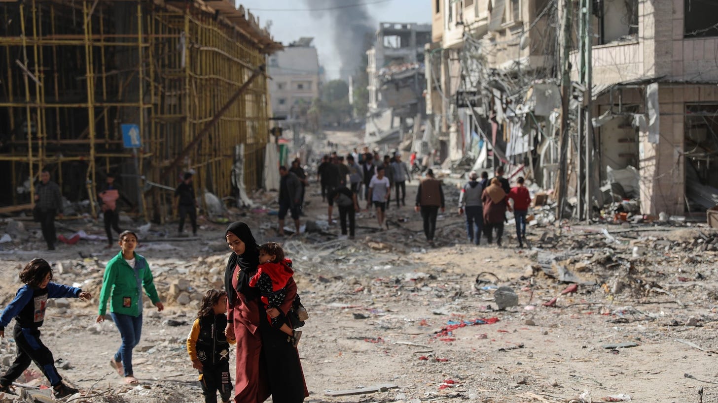 Palestinian families walk through destroyed neighbourhoods in Gaza City on 24 November 2023 as the temporary truce between Hamas and the Israeli army takes effect (MEE/Mohammed al-Hajjar)