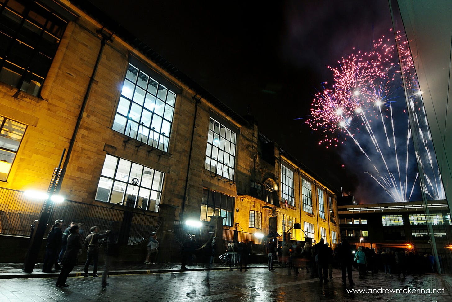 Fireworks to the right of the Glasgow School of Art at night