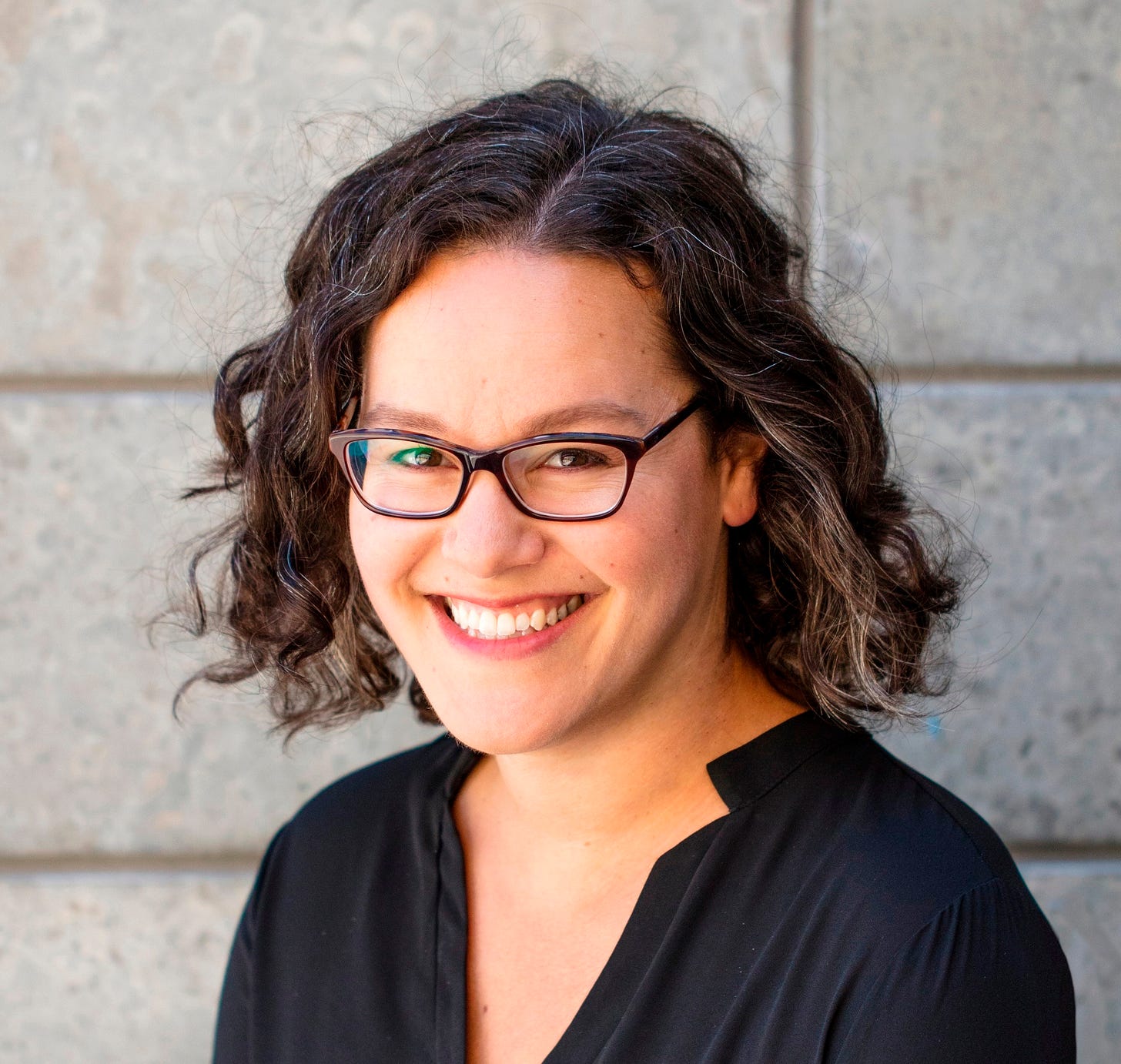 photo of Maggie Hoffman with black shirt and glasses
