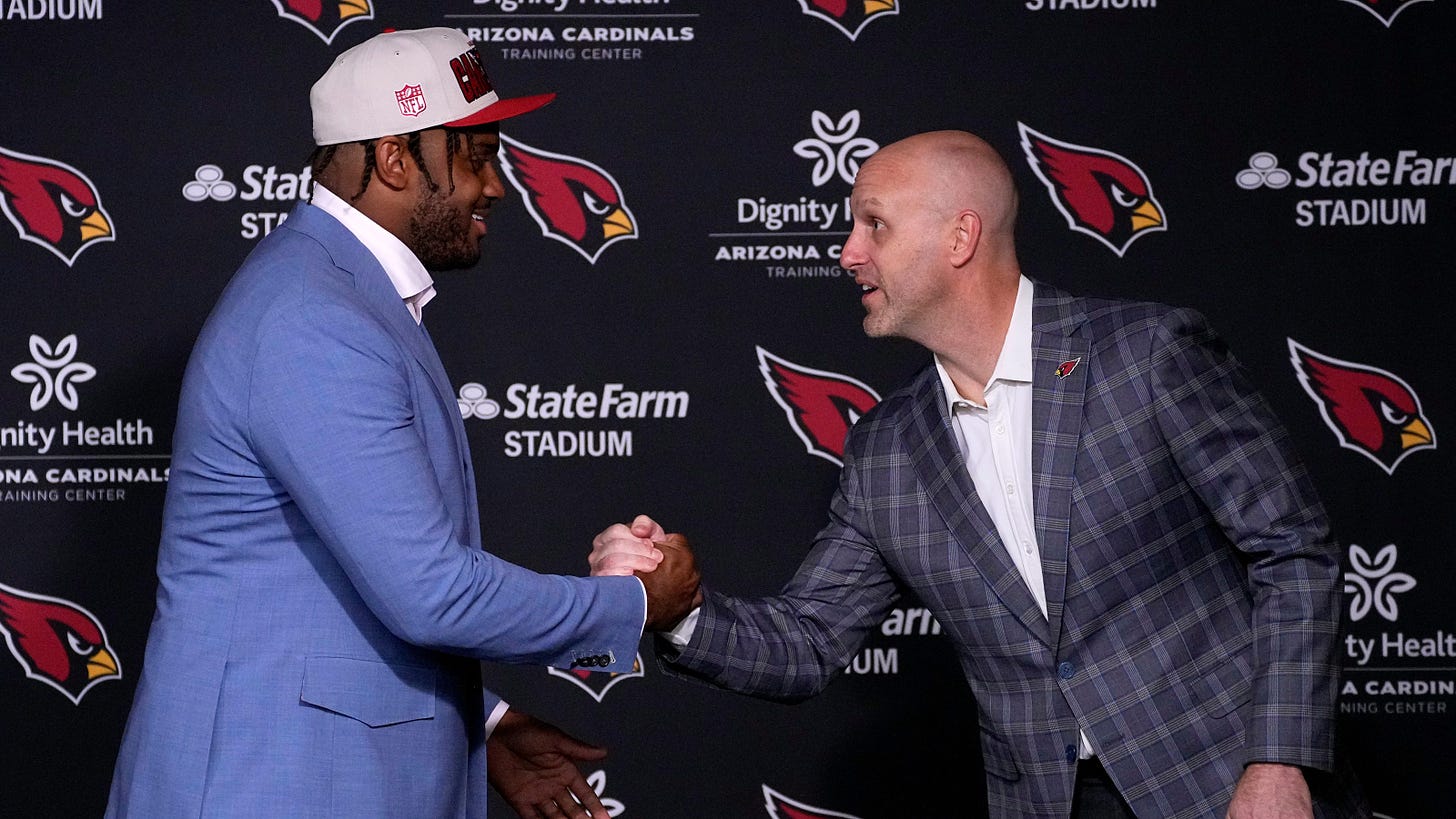 Arizona Cardinals' General Manager Monti Ossenfort shakes hands with one of the selections from the 2023 NFL Draft