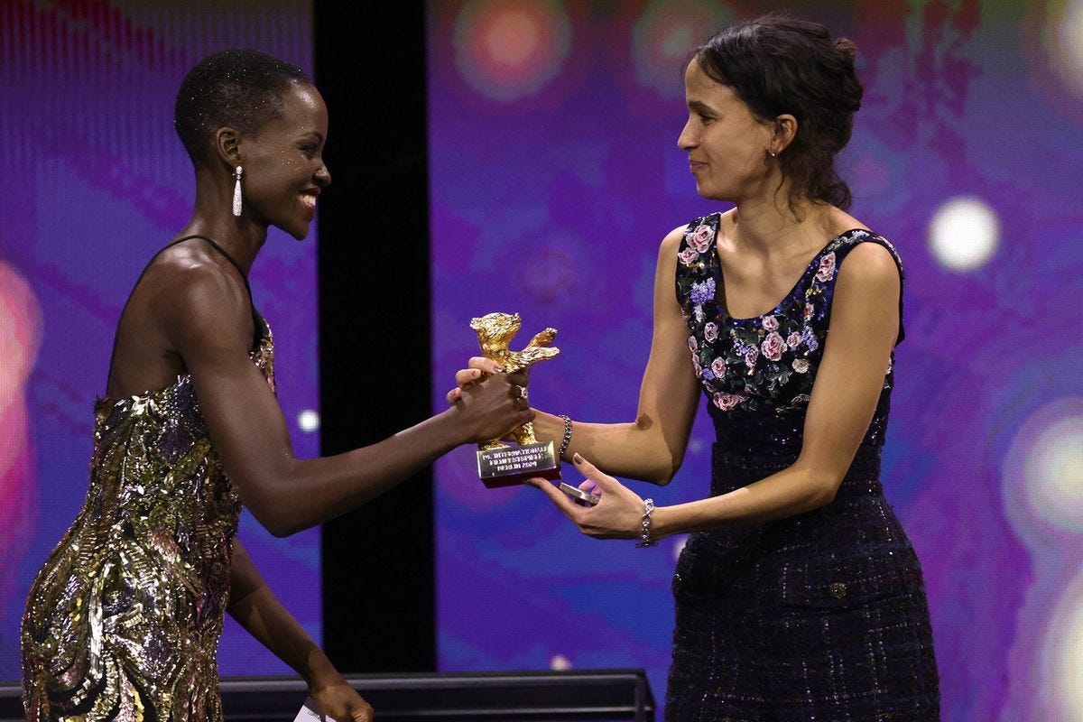 Mati Diop accepts the Golden Bear for Best Film for the film "Dahomey" by President of the International Jury 2024 Lupita Nyong'o on stage at the Award Ceremony of the 74th Berlinale International Film Festival Berlin at Berlinale Palast on February 24, 2024 in Berlin, Germany. 