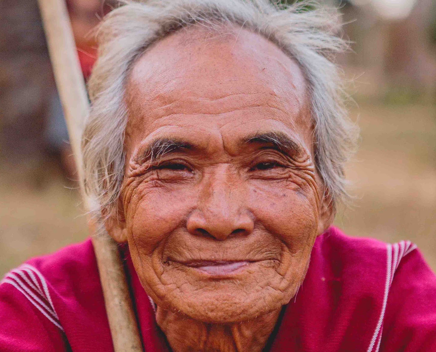 Elderly Tibetan man with wisdom in his eyes showing how we can look when we're old living a high vibration life