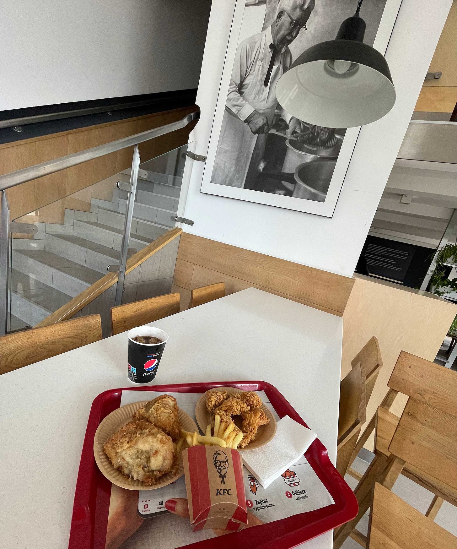 Fried chicken on table inside KFC restaurant.