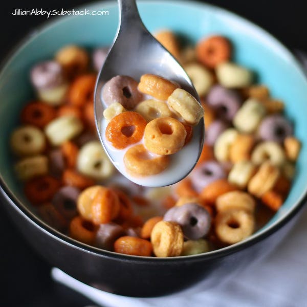 A bowl of rainbow colored circular cereals