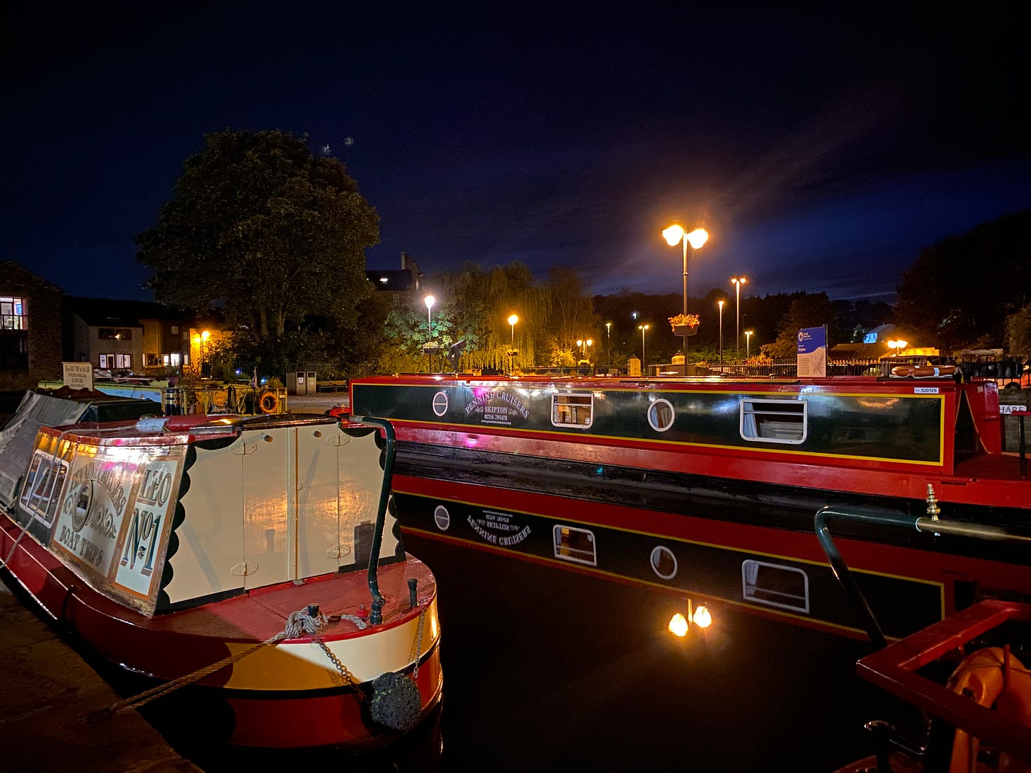 Canal boats on a canal at night