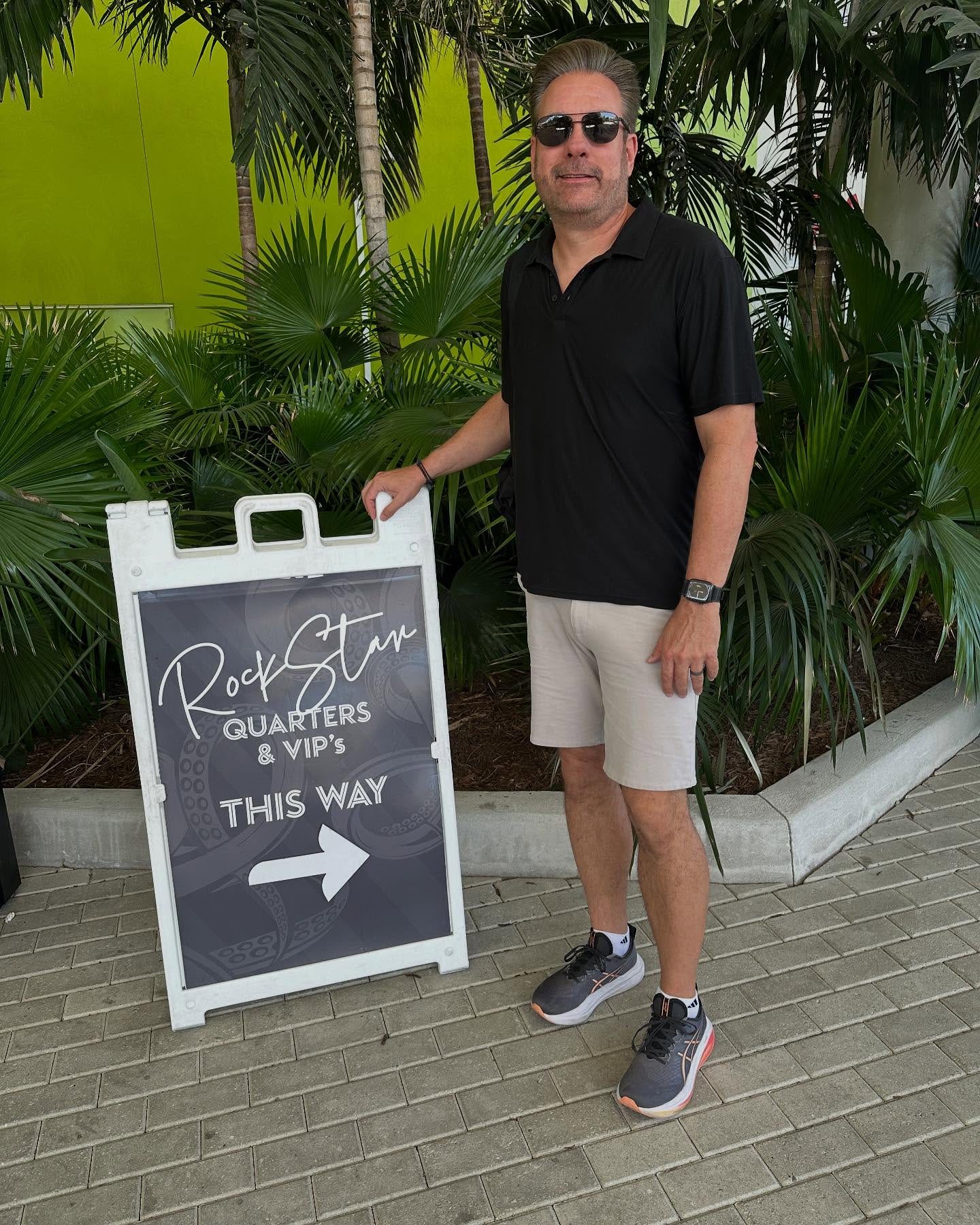 May be an image of ‎1 person, eyewear and ‎text that says '‎RocSter سان QUARTERS & VIP's THIS → WAY‎'‎‎