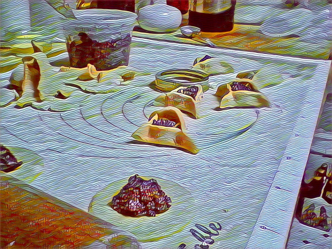 Stylized photo of hamantaschen in progress. Poppy seed, of course.
