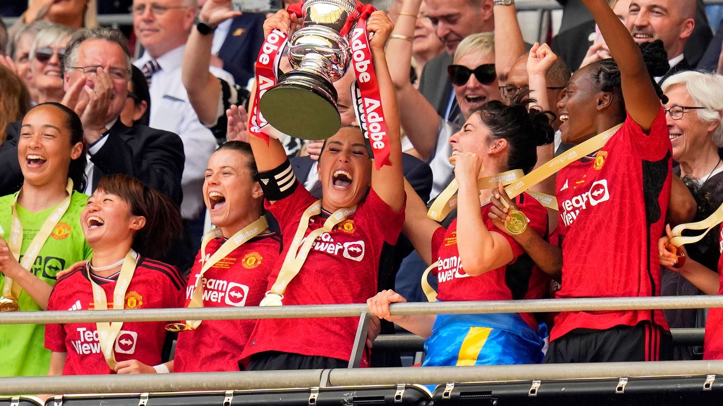 Former United captain Katie Zelem lifting the FA Cup trophy