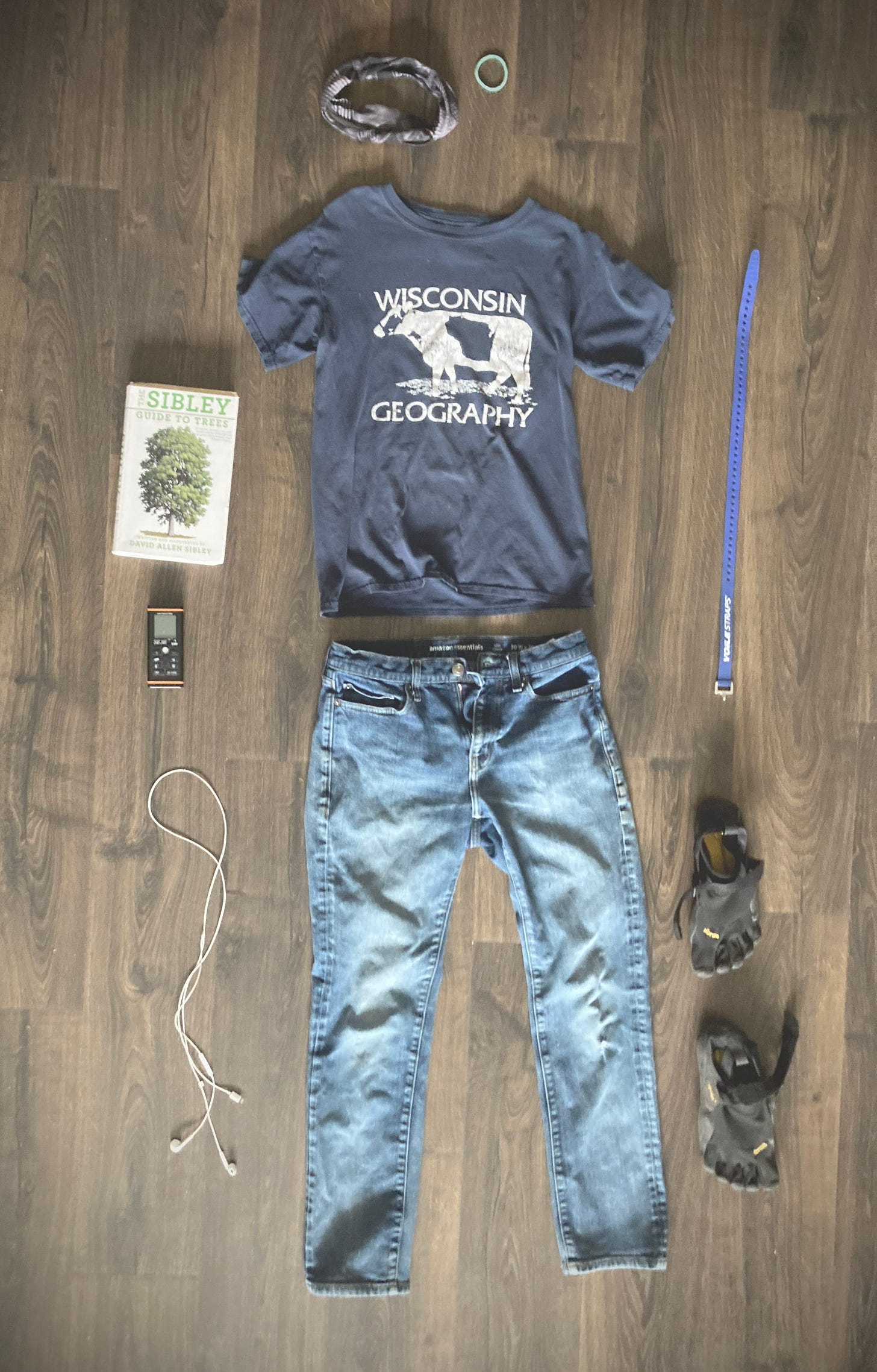 A photo of almost all the gear I will talk about: pants, shoes, shirt, laser ruler, book, etc.