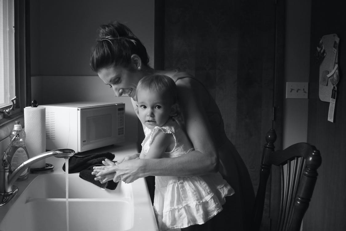 Free Grayscale Photography of Mother Helping Her Baby to Wash Her Hands Stock Photo
