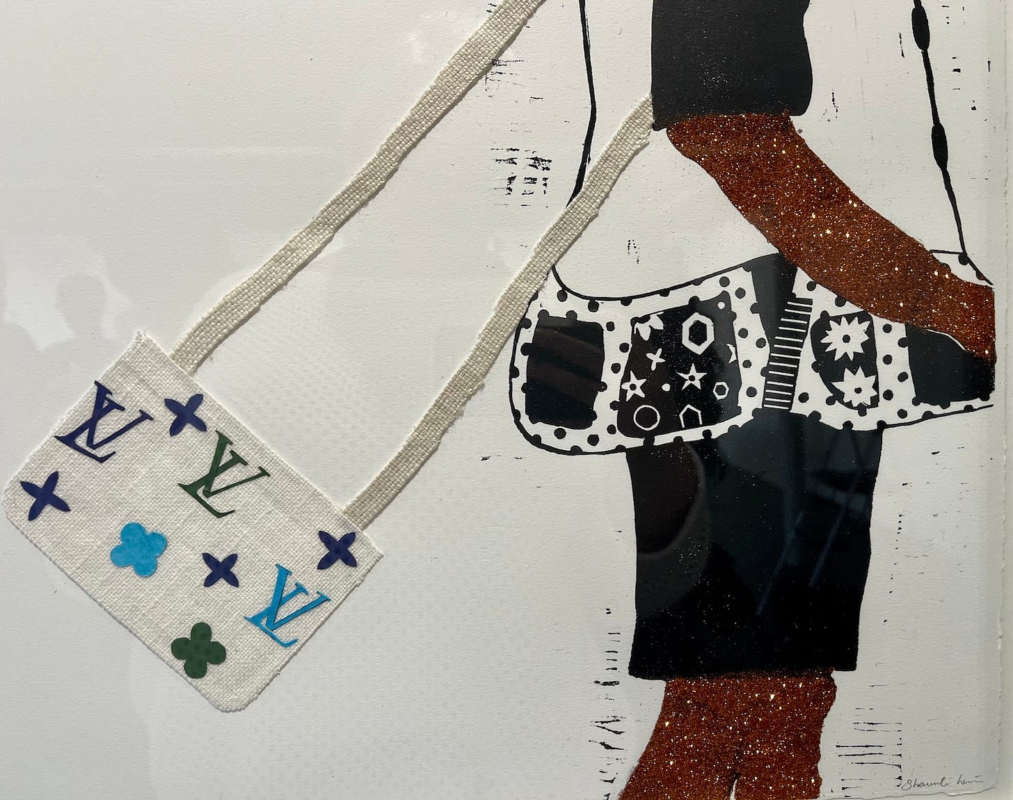 A detail of one of the works in Shaunte' Levine's exhibition "Go'n Grab Your Little Purse." The black-and-white print of a young black girl is layered with glitter (on her arms and legs) and using textiles and vinyl stickers, Levine created a "Louis Vitton" purse for her to carry over her shoulder.