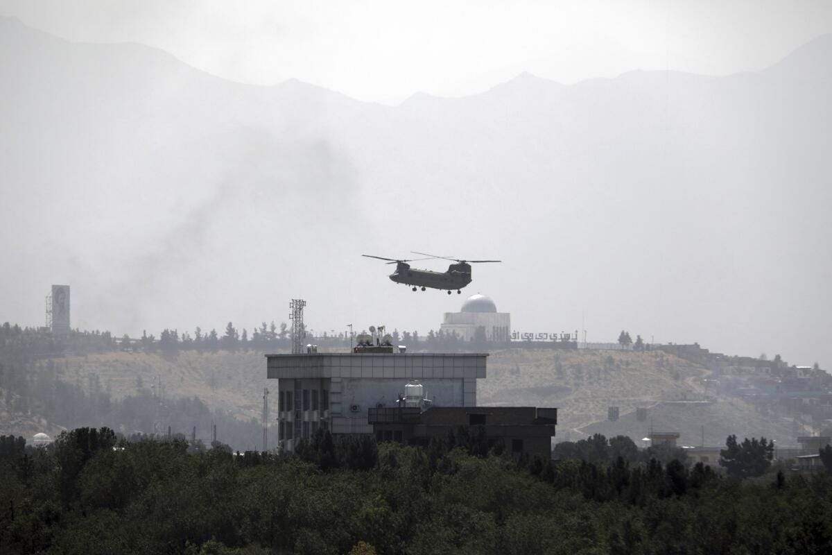 A helicopter hovers over a building against the backdrop of a mosque and mountains A helicopter hovers over a building against the backdrop of a mosque and mountains