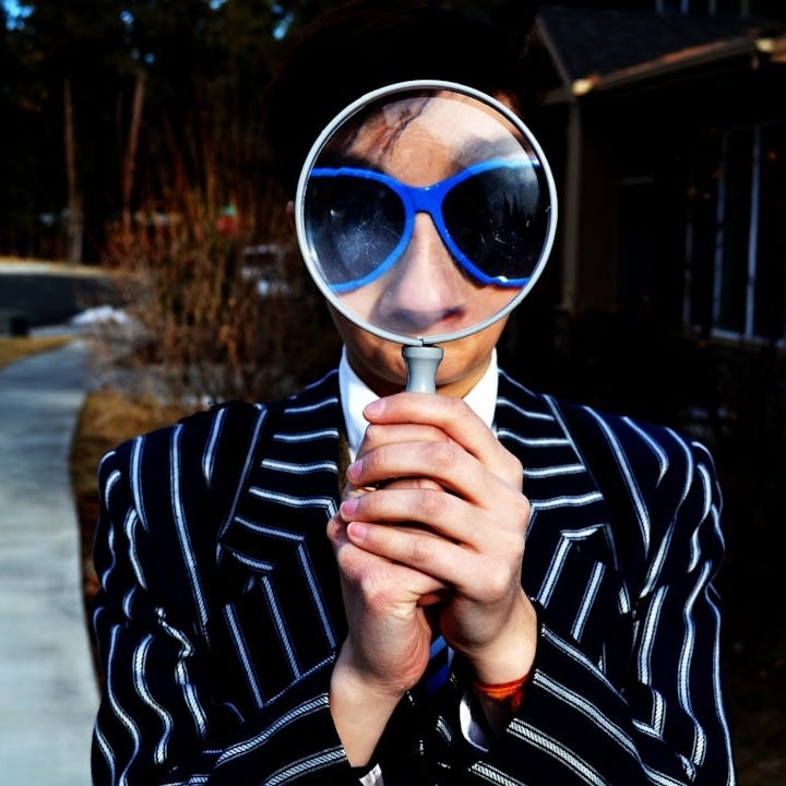 person using magnifying glass enlarging the appearance of his nose and sunglasses person using magnifying glass enlarging the appearance of his nose and sunglasses