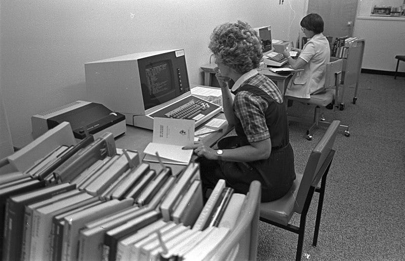 File:University of Texas at Arlington Library, woman working at early version of computers (10003731).jpg