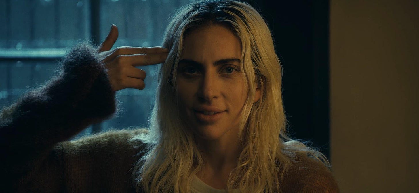 In the new Joker 2 trailer (2024), Gaga's Harley Quinn is shown with what  looks to be a gun to her head. But if you look closely, it's actually her  hand indicating