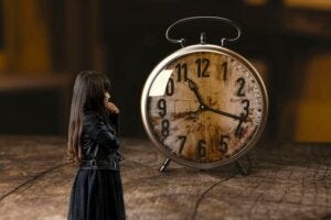 girl watching a giant clock