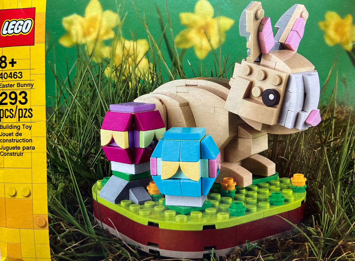 Photo of LEGO 40463 Easter Bunny box. A small build with a cute brown bunny next to 2 easter eggs and flowers on a green base.