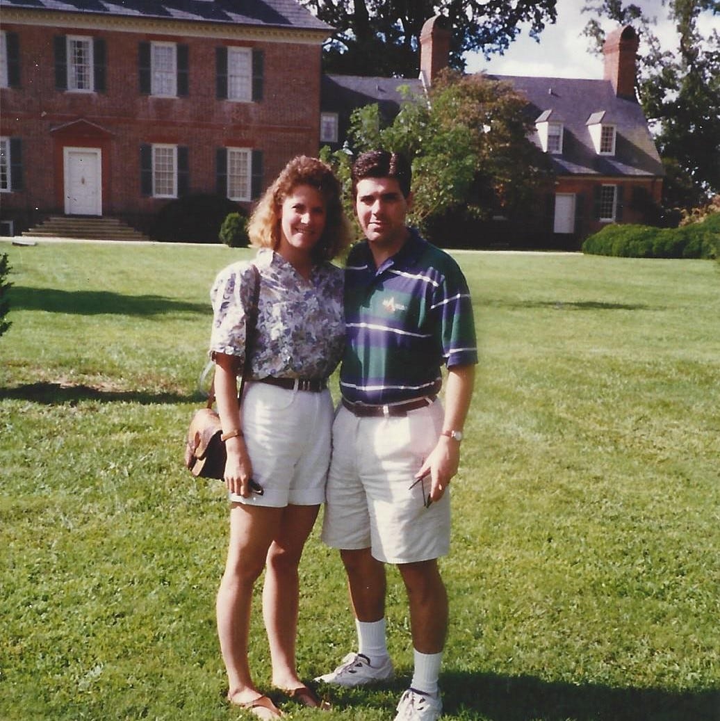 A young couple poses on the lawn outside Carters Grove mansion