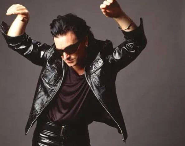 Bono posing in leather and sunglasses