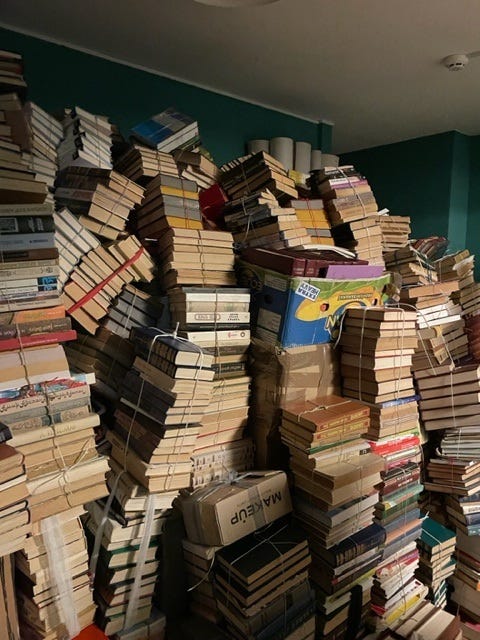 Russian-language books stacked in a back room of Syaivo Books. 