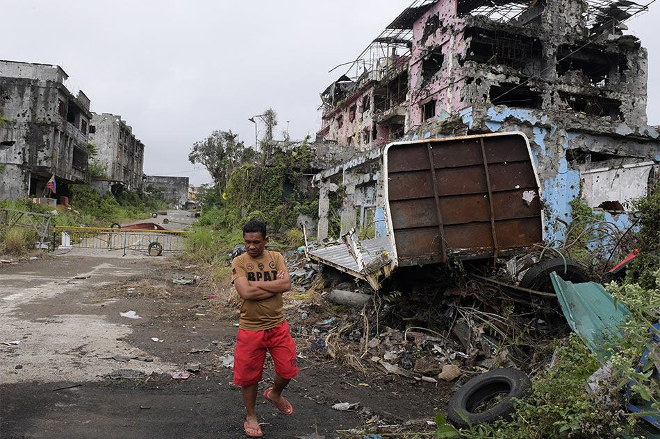 A resident walks back before reaching a fence set up by soldiers in Bangolo, Marawi City on March 19, 2018. Most of the commercial and downtown areas of Marawi City are still off-limits to residents who have been staying in tents and temporary shelters for more than two years. Froilan Gallard, ABS-CBN News/File