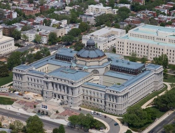 Aerial view of the Library of Congress: a dome surrounded by a block of halls and galleries