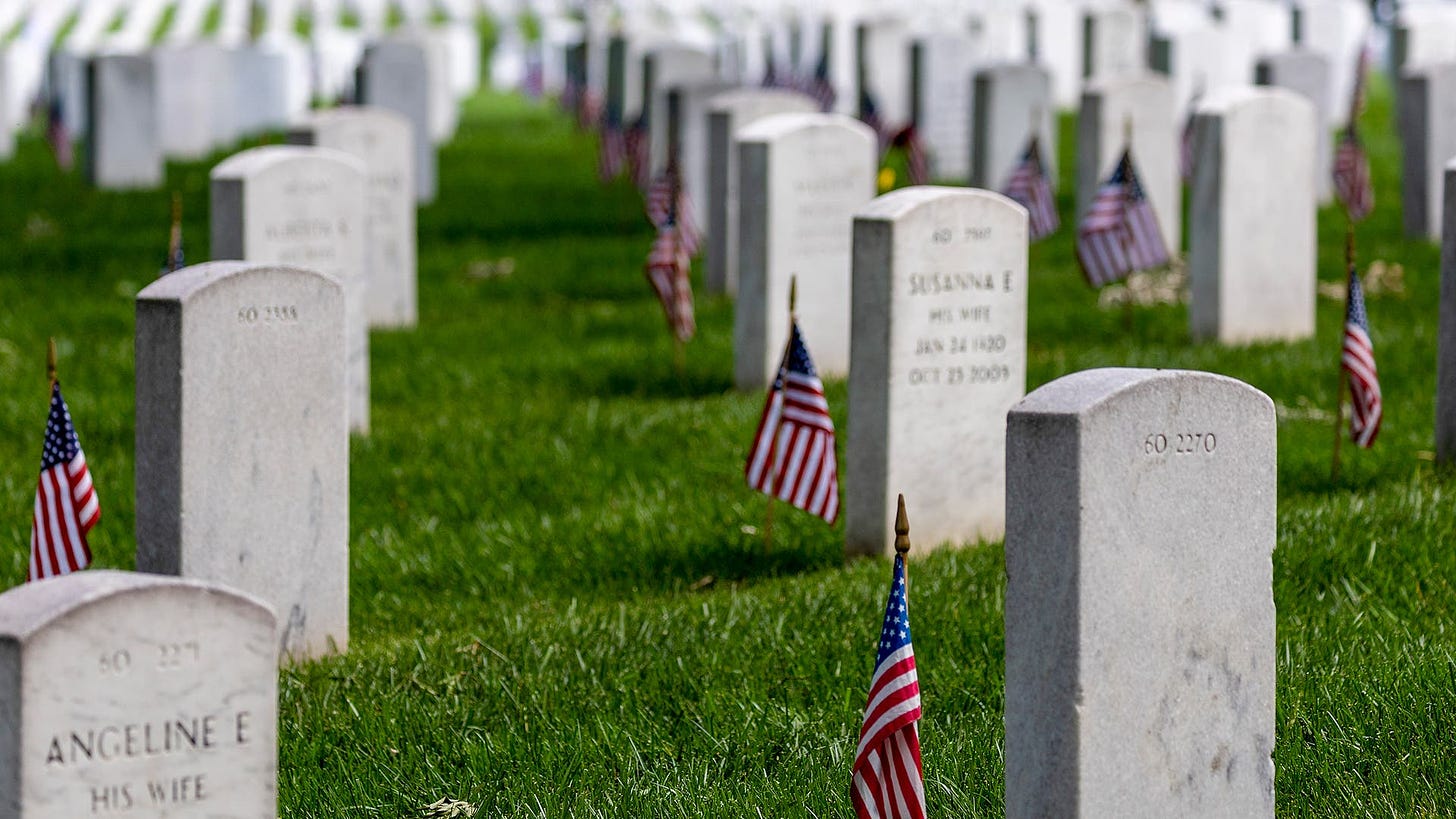 Headstones with American flags are seen at Arlington National Cemetery on May 30, 2022 in Arlington, Virginia. Memorial Day events are being held across the U.S. to honor those who died in active military service.