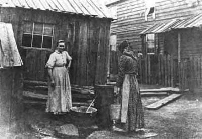 Mine owners constructed and rented shanty-type houses to their workers, mostly immigrant laborers. Here, women are drawing water from one well, which had to supply twenty-five families. Mine owners constructed and rented shanty-type houses to their workers, mostly immigrant laborers. Here, women are drawing water from one well, which had to supply twenty-five families.