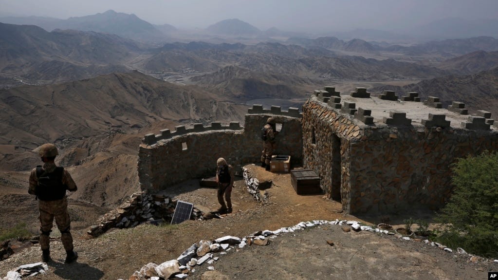 FILE - Pakistan Army troops observe the area from a hilltop post on the Pakistan-Afghanistan border on Aug. 3, 2021. A raid by militants early Sept. 6, 2023, targeted Pakistani posts in the mountainous Kalash border valley.