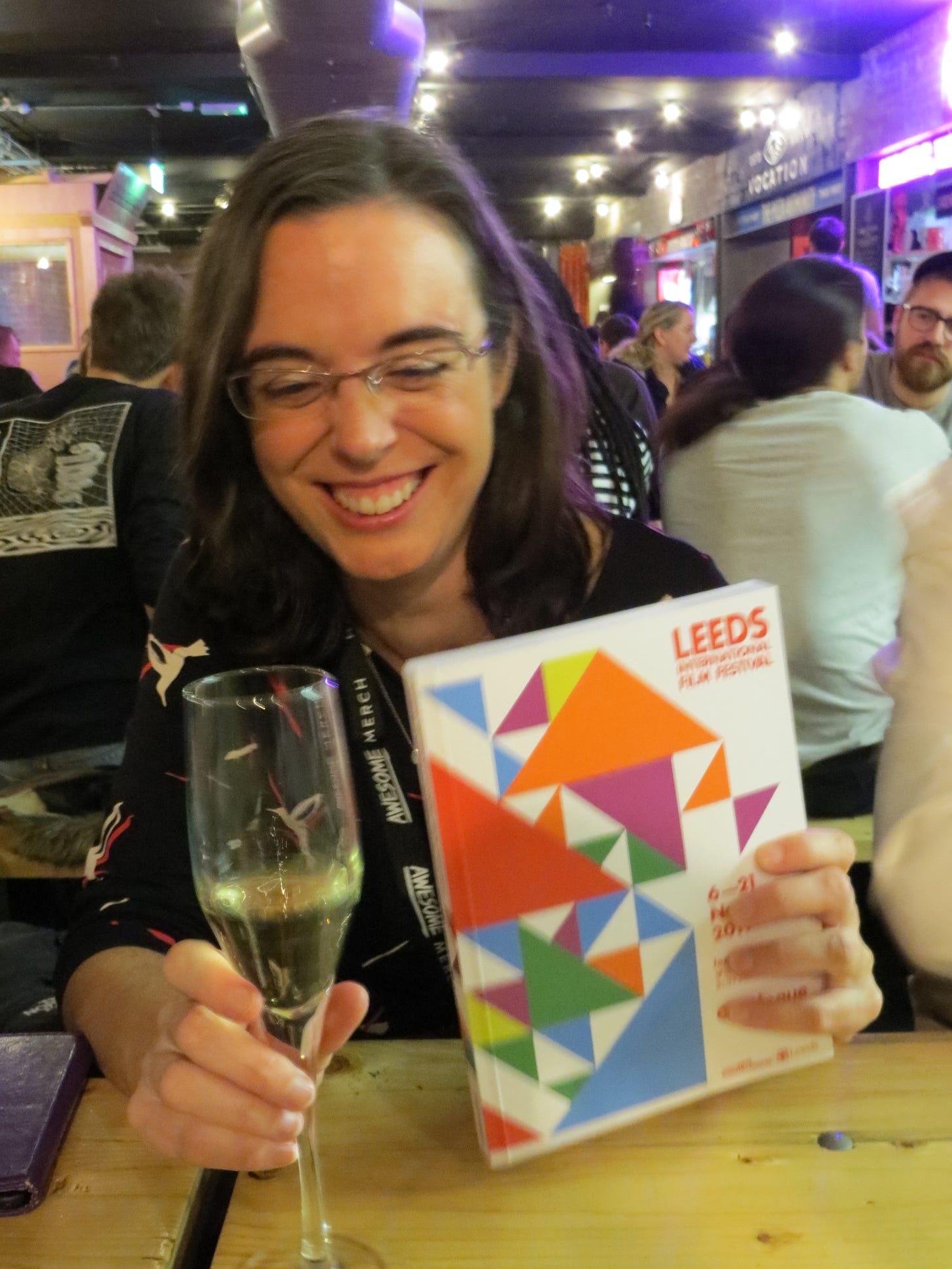 Vicki with film festival programme & glass of champagne