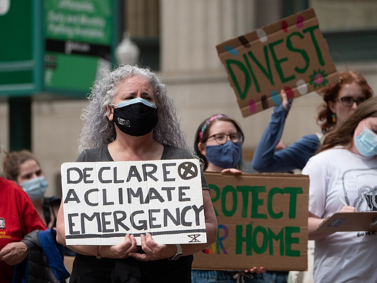 people in a demonstration hold up signs that say protect our home and declare a climate emergency people in a demonstration hold up signs that say protect our home and declare a climate emergency