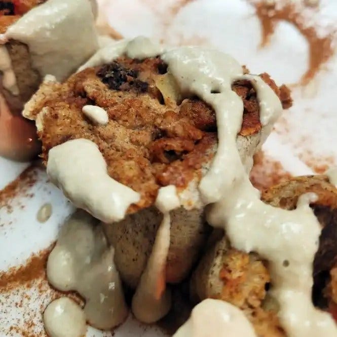 Cinnamon Apple-Raisin Roll dripping with icing closeup