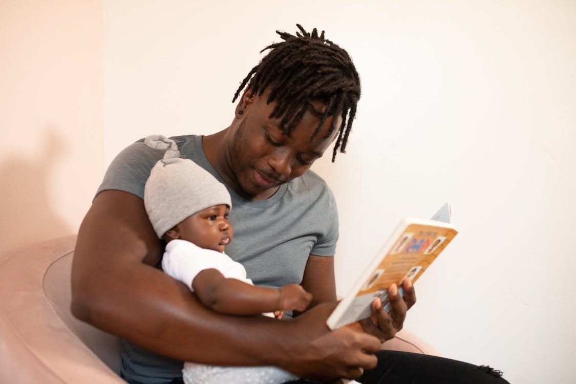 Free Man in Gray Shirt Holding Baby in White Onesie Stock Photo