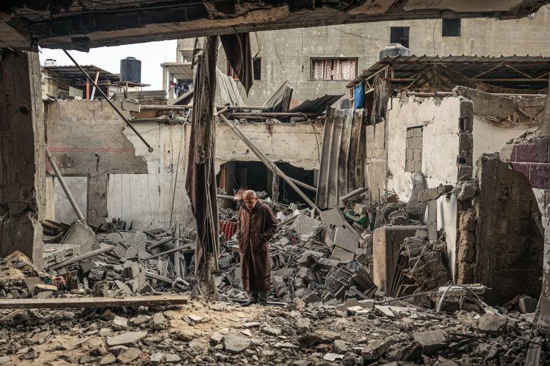 A Palestinian man walks amidst debris following Israeli bombardment in Rafah A Palestinian man walks amidst debris following Israeli bombardment in Rafah