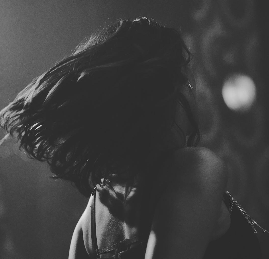 a black and white photo of a woman in lingerie