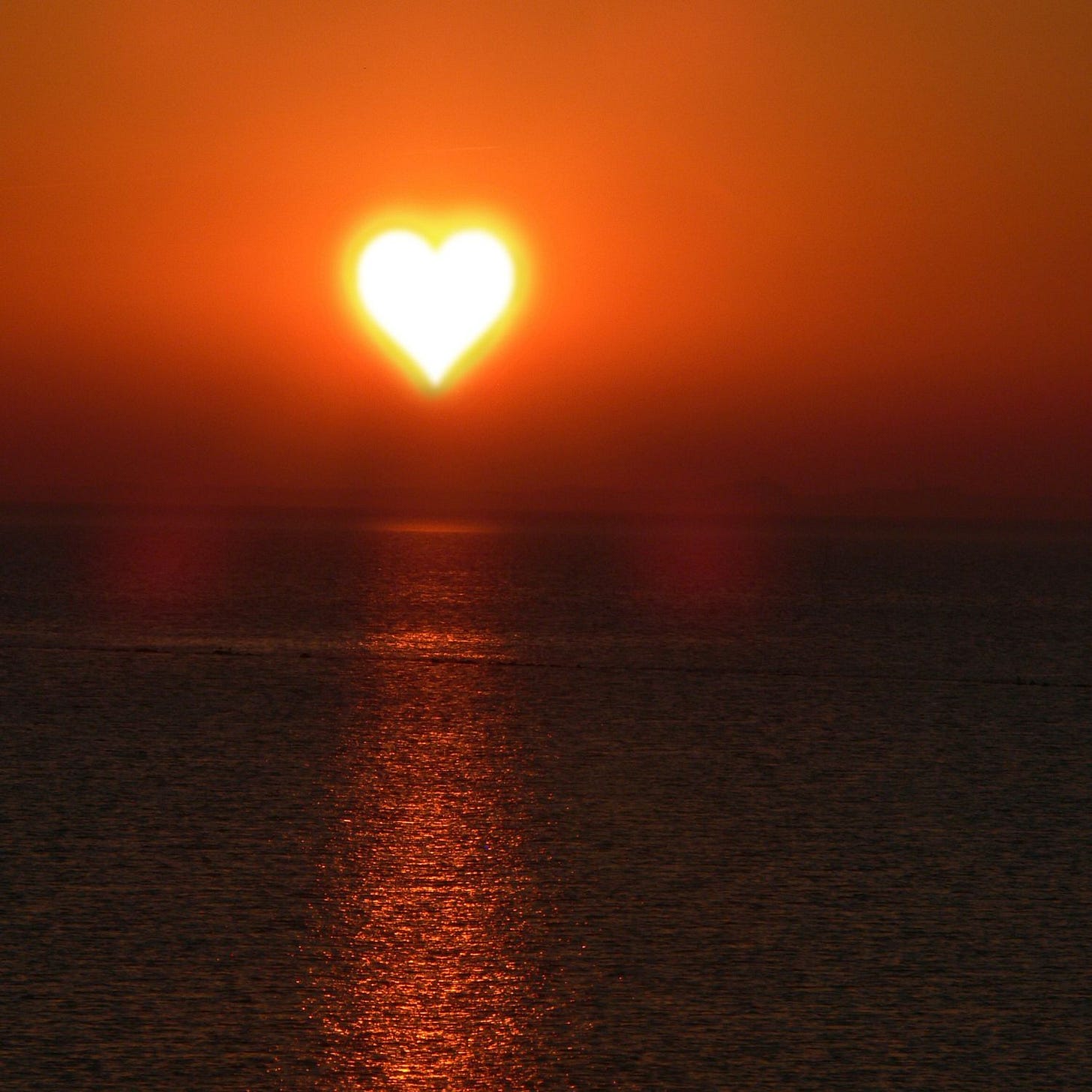 yellow heart in orange red sky