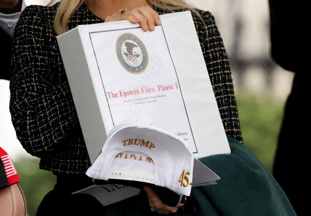 People exiting the West Wing of the White House holding 'The Epstein Files: Phase 1' binders, during a meeting of U.S. President Donald Trump and British Prime Minister Keir Starmer.