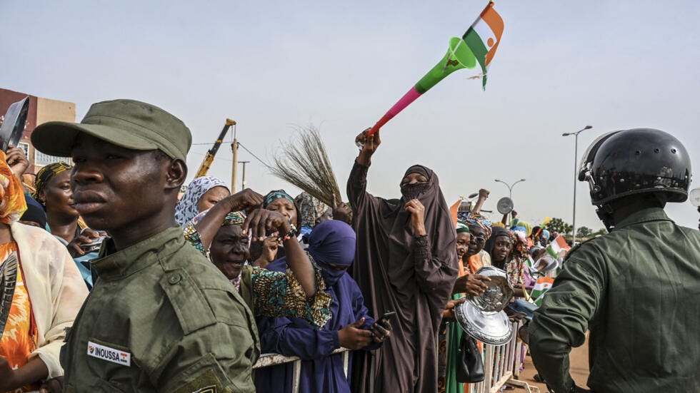 Niger's national police officers stand guard as protesters gather outside the Nigerien and French airbase in Niamey on August 30, 2023 to demand the departure of French troops.