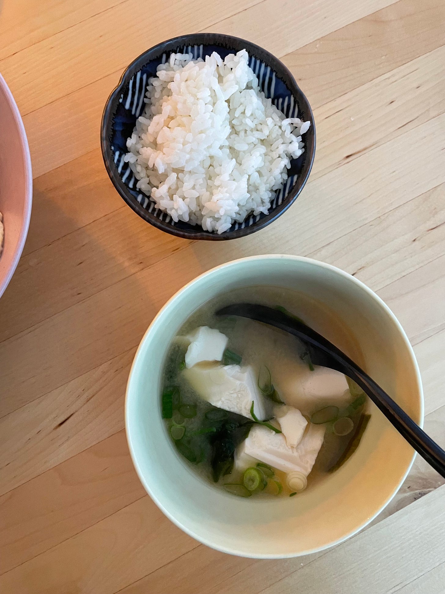 Comforting dinner made from a bowl of sushi rice, and a larger bowl of miso soup