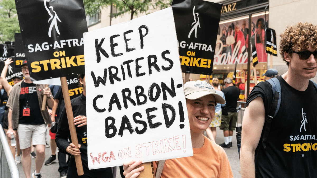 A picket sign reading "Keep Writers Carbon-Based"