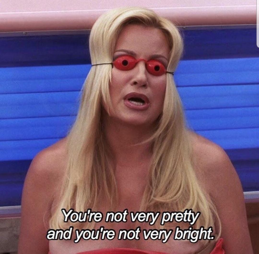 Still from A Cinderella Story showing Sam's stepmother Fiona (played by Jennifer Coolidge) in her tanning bed with her weird little googles on, saying "You're not very pretty, and you're not very bright"