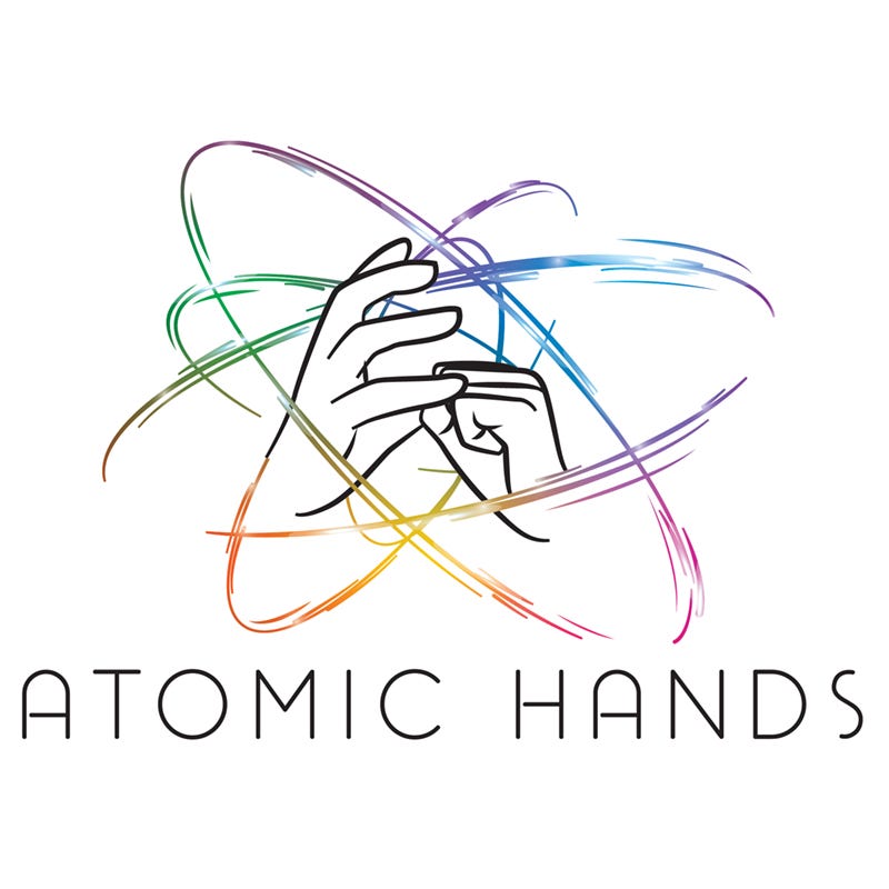 Logo for Atomic Hands. Colorful lines whooshing through atomic orbital pattern in the background, two hands reflecting the shape in the foreground. The name "Atomic Hands" is at the bottom in all caps.