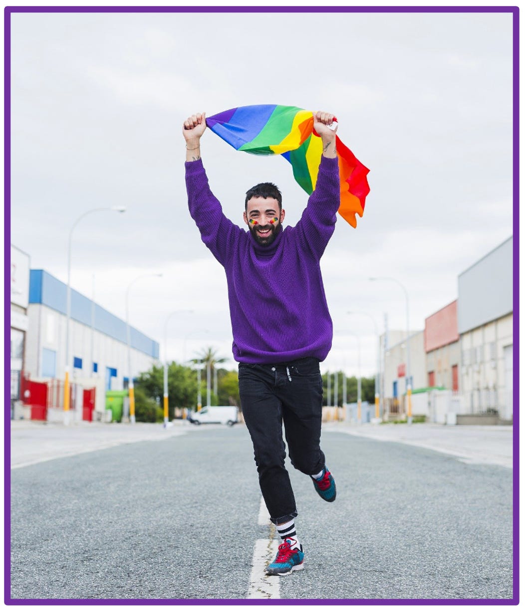 Young man running, holding Pride flag